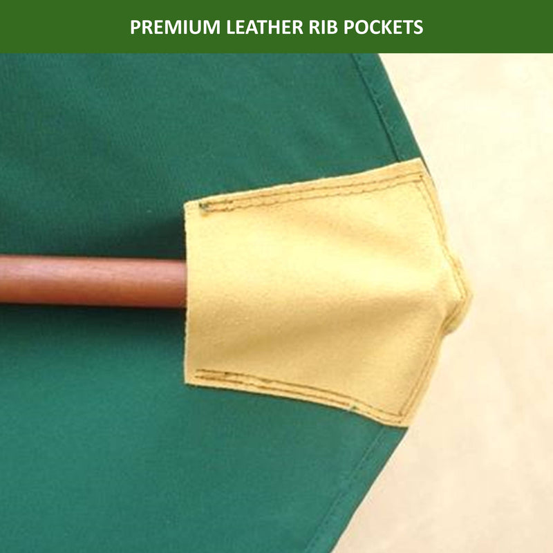 Close-up of a green fabric canopy with a wooden rib inserted into a beige leather rib pocket for added durability. The UV-treated, durable hunter green canopy of the Formosa Covers 11ft Market Patio Umbrella Double-Vented 8 Rib Replacement Canopy extends outward, and the text at the top reads "PREMIUM LEATHER RIB POCKETS.