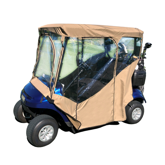 A blue, 2-seater golf cart equipped with the Formosa Covers 2 Passengers Driving Enclosure Roof 56" - 60" Straight Down Tail in Taupe Golf Cart Cover. This tan, transparent all-weather cover shields both the driver and passenger areas, featuring zippered openings for convenient access and is designed to protect from weather elements. The cart is parked on grass with a golf course visible in the background.