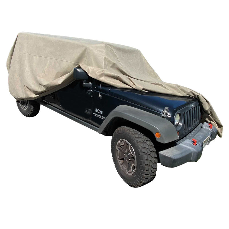 A heavy-duty, dark green off-road vehicle with large tires is partially covered with the Formosa Covers Jeep Cover fit for 1976-2006 Jeeps in taupe. The cover drapes over the hood and roof, leaving the sides, front, and tires exposed. The vehicle is shown on a white background.