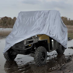 A rugged all-terrain vehicle, partially covered with a Formosa Covers UTV Cover - Extra Large (160