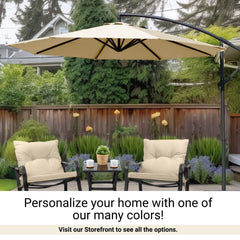 A backyard patio featuring two cushioned chairs with a small table in between, holding potted plants and mugs. An 11ft Cantilever Hanging Umbrella with 8 Rib Replacement Canopy in Taupe from Formosa Covers provides shade. The background has lush greenery and a wooden fence. Text reads: 