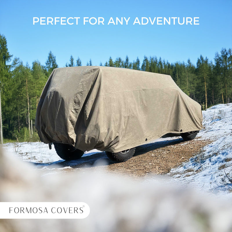 A van, fully shielded with a rugged, taupe cover designed for 1976-2006 Jeeps, is parked on a snow-dusted ground surrounded by trees. The words "PERFECT FOR ANY ADVENTURE" are displayed at the top while "FORMOSA COVERS" is prominently shown at the bottom.