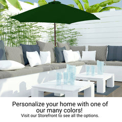 Enjoy your outdoor patio with gray and white striped seating, complemented by a green umbrella and white coffee tables. The space is adorned with leafy plants in the background for a serene ambiance. Personalize your home with a burst of color using the 9ft Market Patio Umbrella 6 Rib Replacement Canopy in Forest Green by Formosa Covers, made from UV-treated, durable polyester fabric. Visit our storefront for more options.