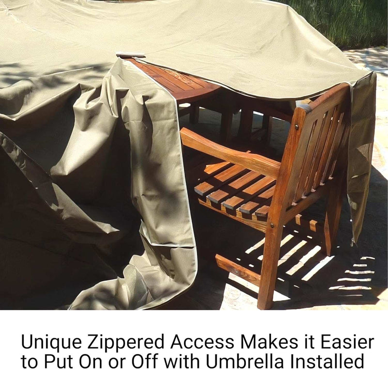 A wooden patio table and chairs are partially protected by a Formosa Covers Patio Set Cover, designed for rectangular or oval tables measuring 160"L x 90"W, featuring an umbrella hole for convenience. The cover is crafted from UV-treated polyester and has unique zippered access, allowing easy use even with an umbrella installed, casting intriguing shadows in the sunlight.