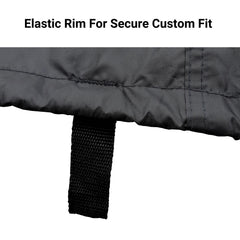 Close-up image of a black fabric with stitching details and an attached adjustable strap loop. Text at the top reads, 