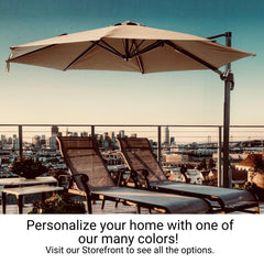 Two lounge chairs and a 10ft Cantilever Supported Bar Umbrella with an 8 Rib Replacement Canopy in taupe, set up on a rooftop terrace overlooking a city skyline at sunset. The promotional text encourages personalizing your home by visiting the Formosa Covers storefront to see color options for our water-resistant umbrellas made with durable non-fray 300 denier polyester fabric.