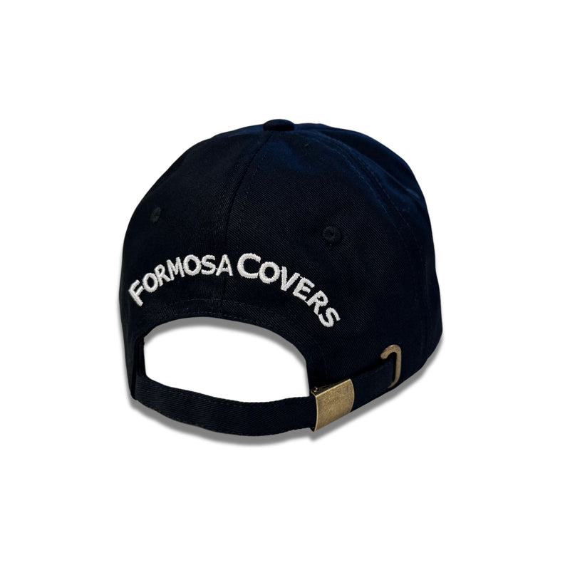 A black Formosa Covers Embroidered Adjustable Dad Hat is displayed from the back. The cotton twill cap features an adjustable strap secured with a brass fastener, and "FORMOSA COVERS" is embroidered in white text above the opening.