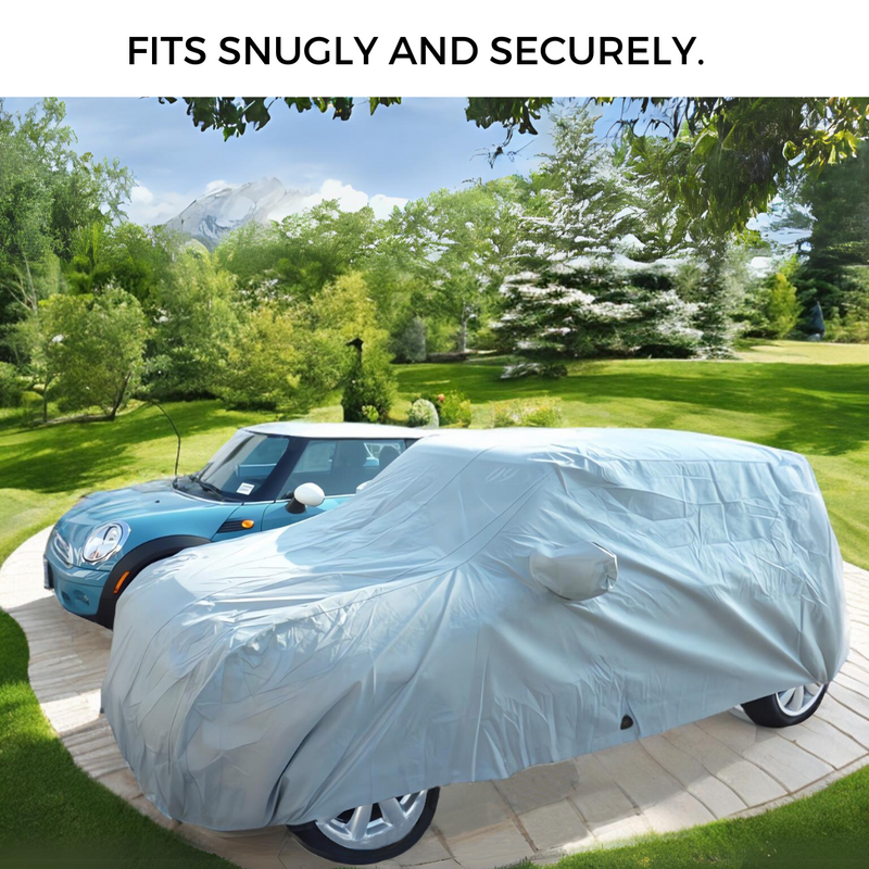 A blue compact car parked on a driveway next to another covered with a Formosa Covers Car Cover for Mini Cooper Hardtop 2 Door and 4 Door, Convertible, Coupe, fitting up to 158"L. In the backdrop, lush green trees, a well-manicured lawn, and mountains stretch into the distance. The text above reads, "FITS SNUGLY AND SECURELY.