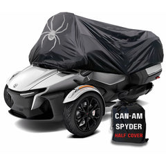 A Can-Am Spyder Touring Model motorcycle is partially covered with a black Formosa Covers half cover featuring a large spider design. The UV-treated fabric ensures durability, and the cover is waterproof. Next to the motorcycle, there’s a storage bag labeled 