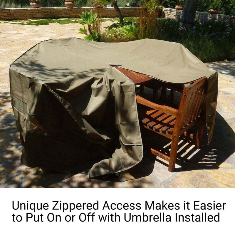 The wooden patio table and chairs set is partially shielded by a Formosa Covers Patio Set Cover, designed for round or square tables and chairs with dimensions of 96" in diameter/length by 30" in height, in a classic taupe hue. Made from UV-treated polyester that resists mildew, the cover features a convenient zipper for easy access and sits on a sunlit stone patio surrounded by lush greenery.