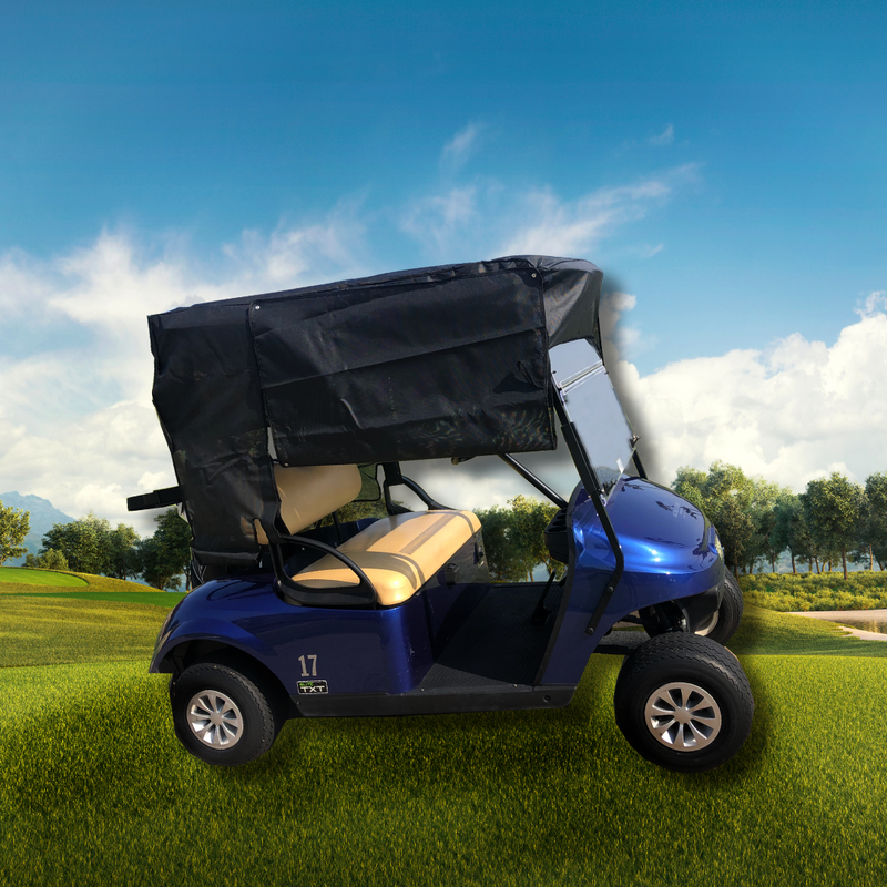 A Formosa Covers Golf Cart, featuring a UV Mesh Top Cover for a 58" short roof in black, is parked on bright green grass under a clear blue sky. The cart, which has blue bodywork and beige seats, displays the number 17 on its front panel. Trees and a sand trap are visible in the background, providing scenic beauty and sun protection for players.