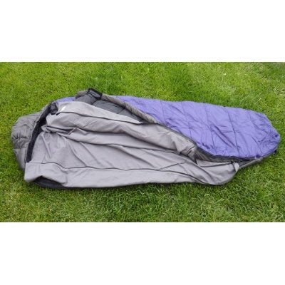 The Formosa Covers Sleeping Bag Liner Hiking Camping Hostel Travel Sack Sheet, featuring a rectangular design with an 80" length and a zipper, is shown on a grassy surface. The liner has the top half in purple and the bottom half in gray, and it is partially unzipped to display the interior.